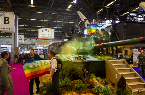Protesters occupy a tank at the Eurosatory arms fair