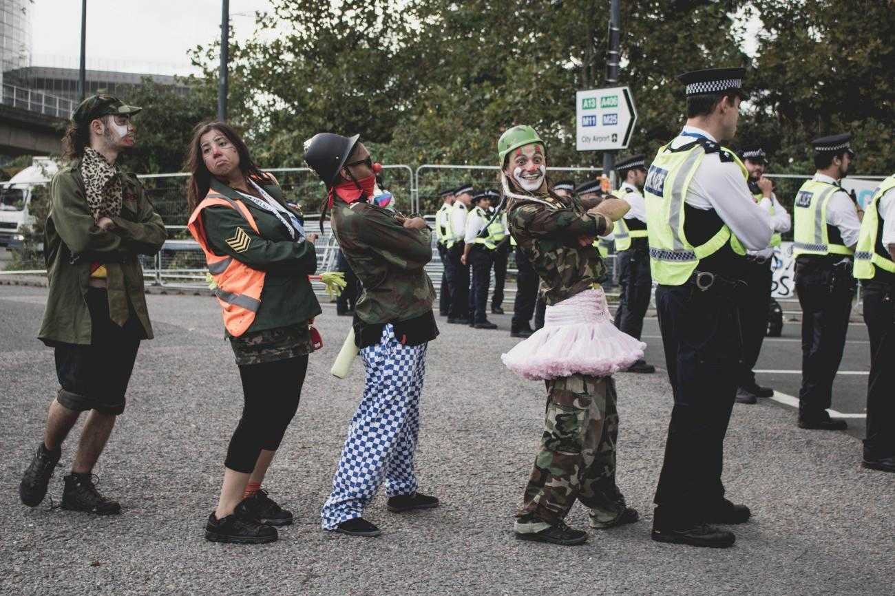 A group of clowns mock police at DSEI protests.