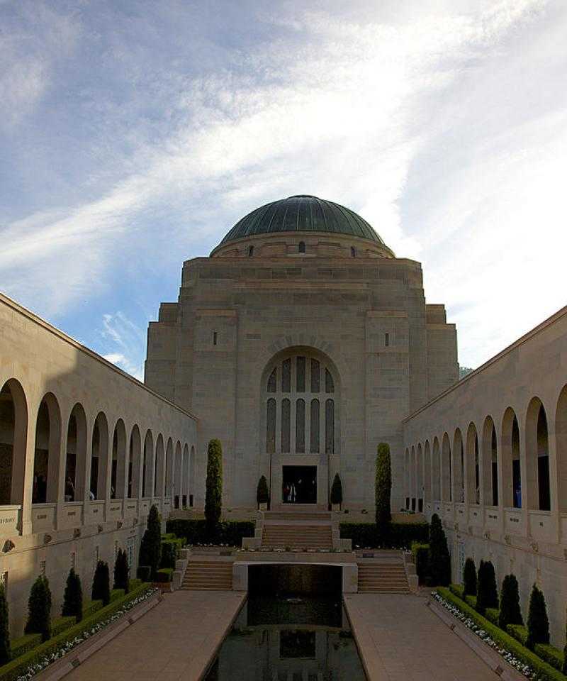 The Australian war memorial - a large stone building with arches and a central grass space