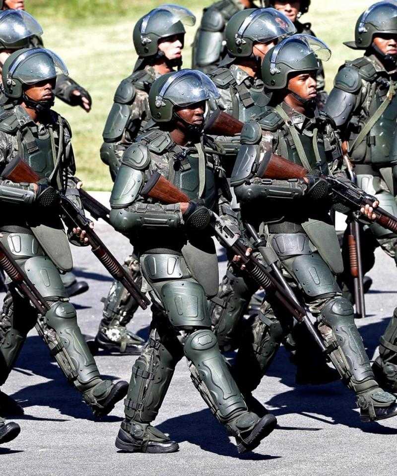 Heavily armed and armoured police in Brazil during the world cup march in formation.