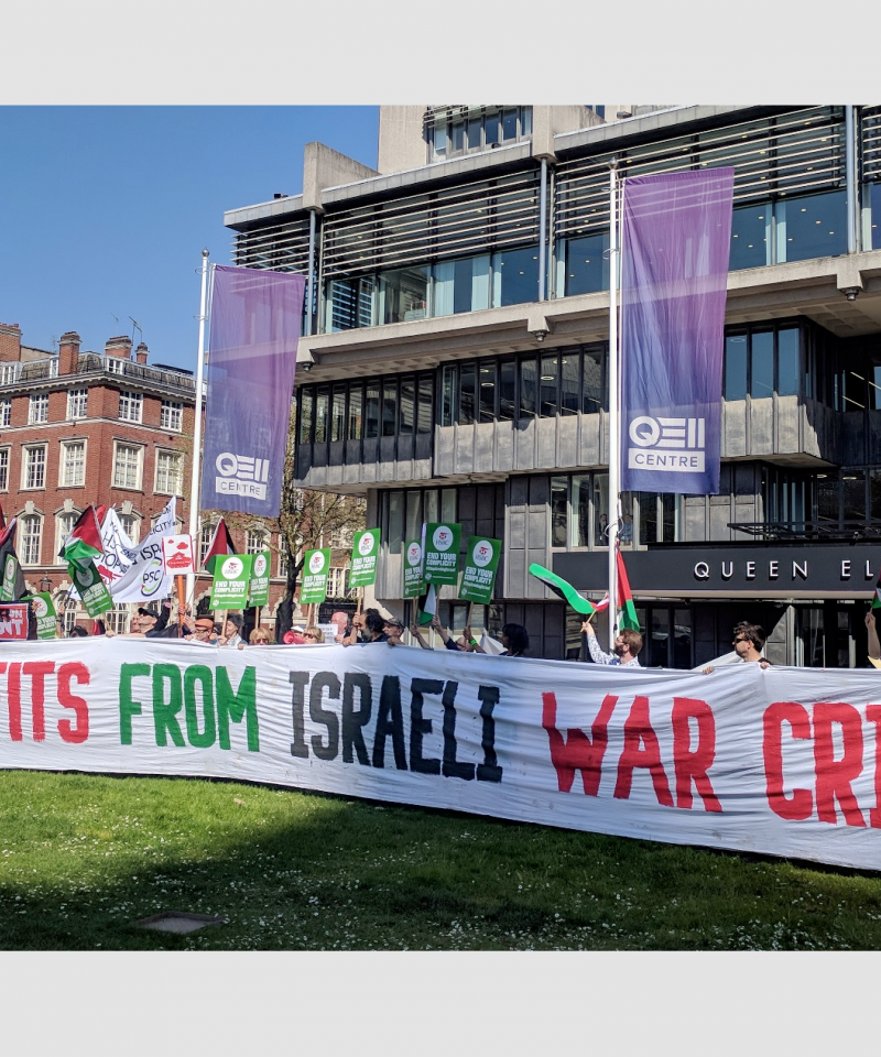 A large group of people stand behind a banner reading "HSBC profits from Israeli war crimes"