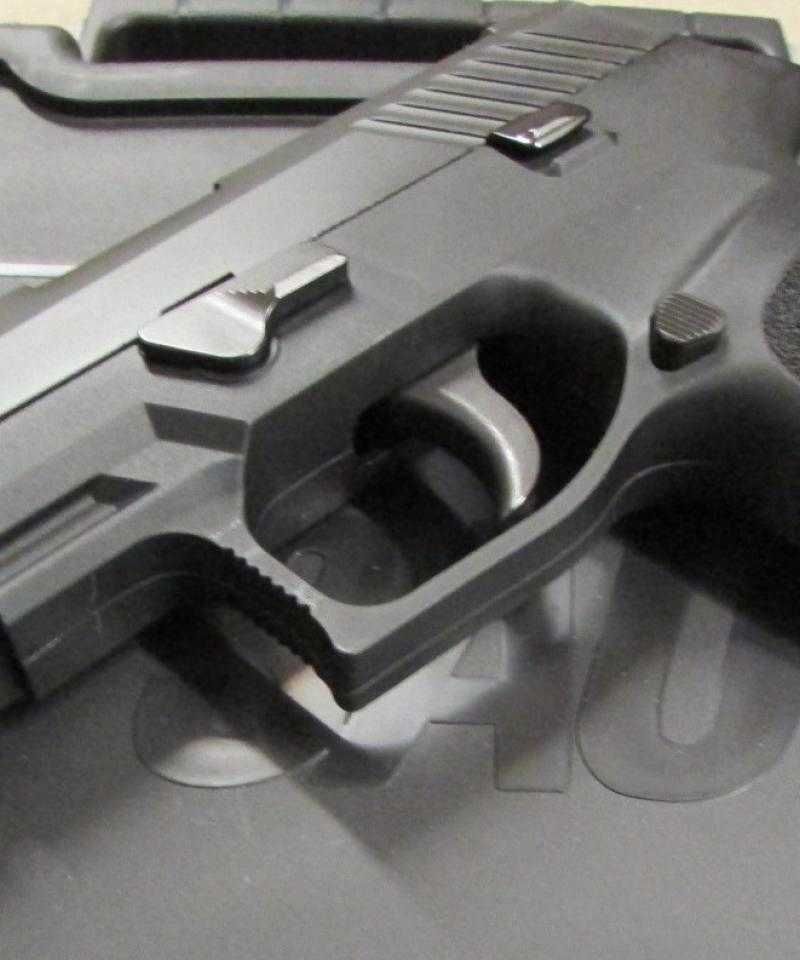 A black hand gun sits on top of a black plastic box