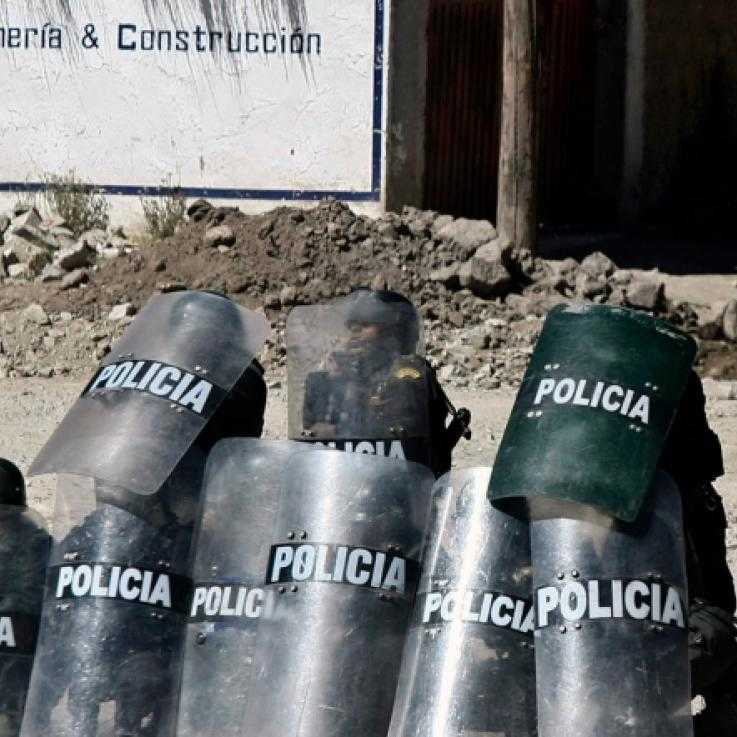 Police holding shields in front of the Tintaya mine in Peru