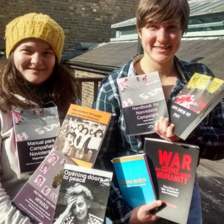Hannah and Taya holding a selection of WRI books