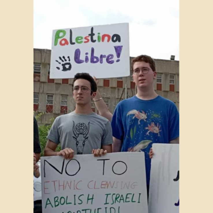 Two people holding banners during a protest